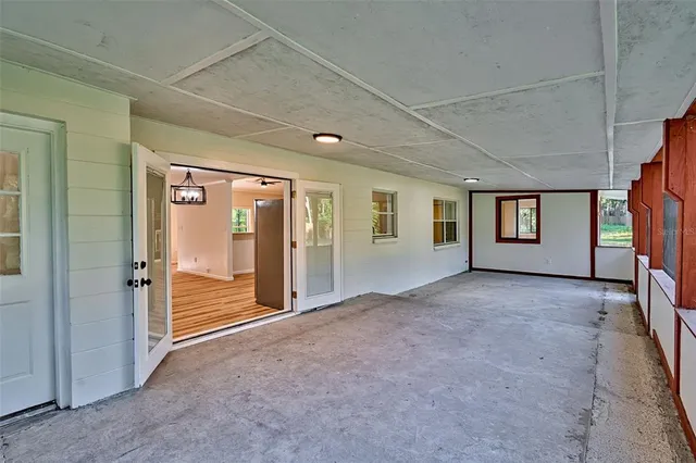 a view of a big room with windows and entryway