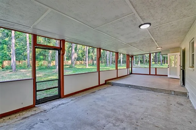 a view of an empty room with windows