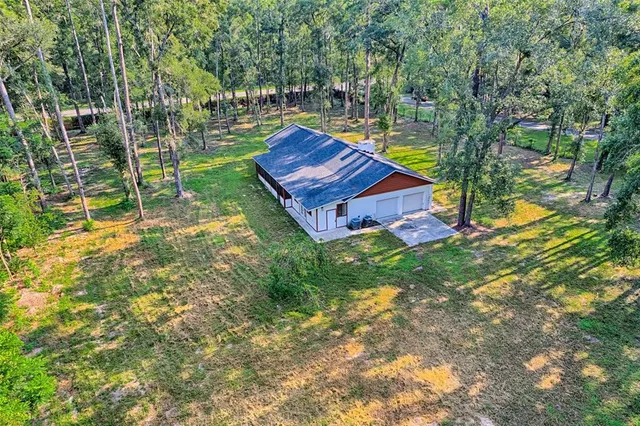 a wooden bench sitting in the middle of a yard