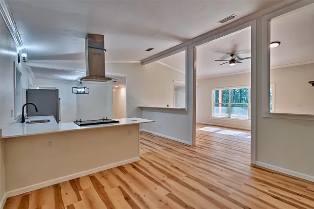 a view of a kitchen with wooden floor