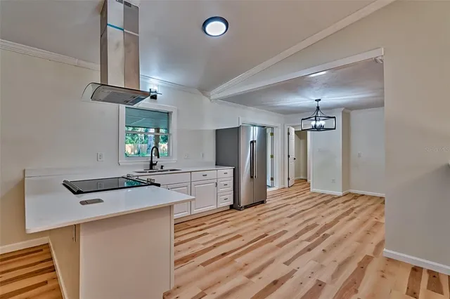 a kitchen with stainless steel appliances kitchen island a refrigerator sink and stove