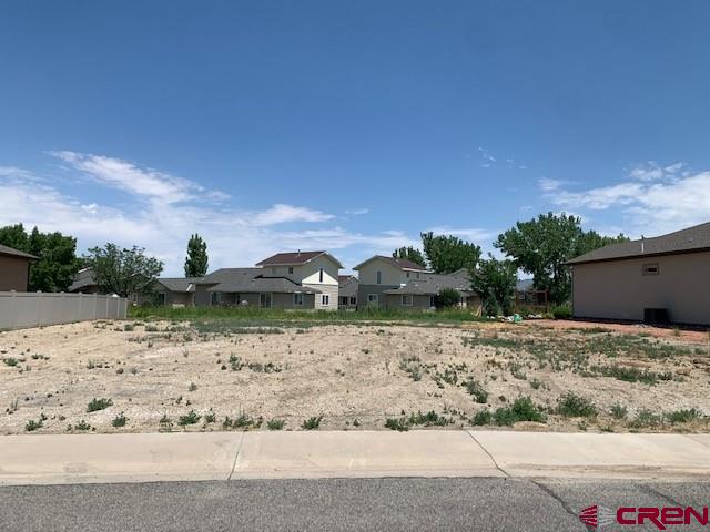 a backyard of a house with a yard and covered with sky view