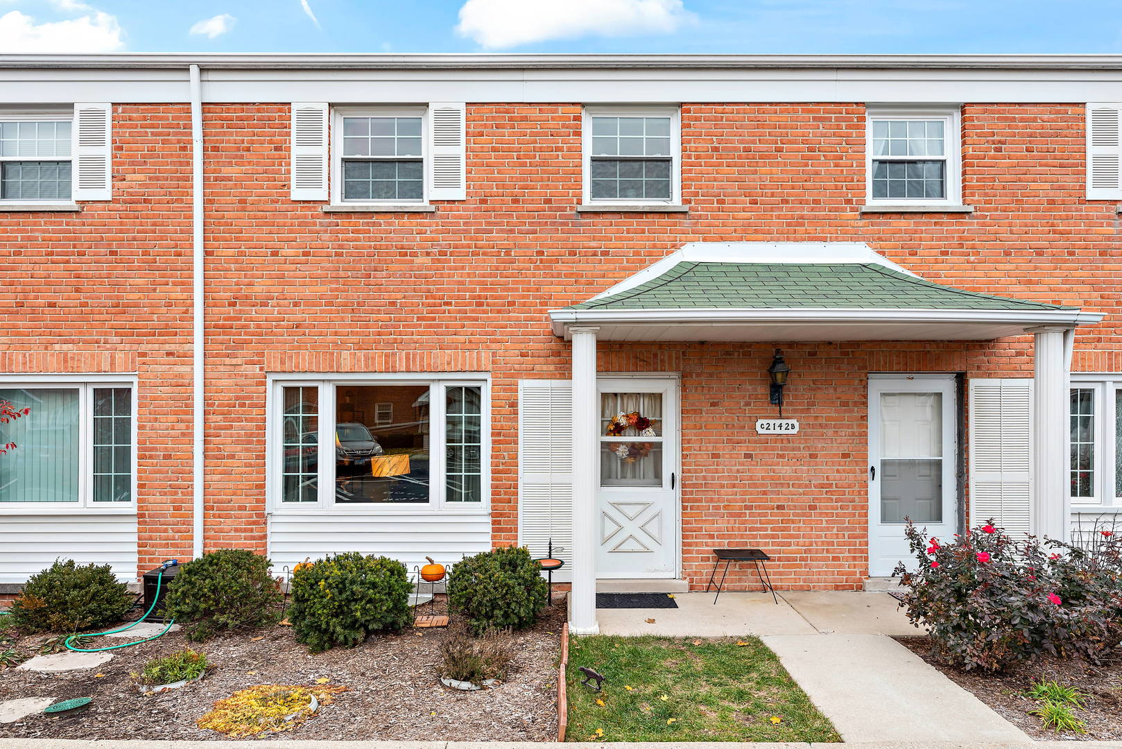 2142 Rugen Road, Unit C Glenview, IL 60026 - Photo 1 of 24 a front view of a house with garden