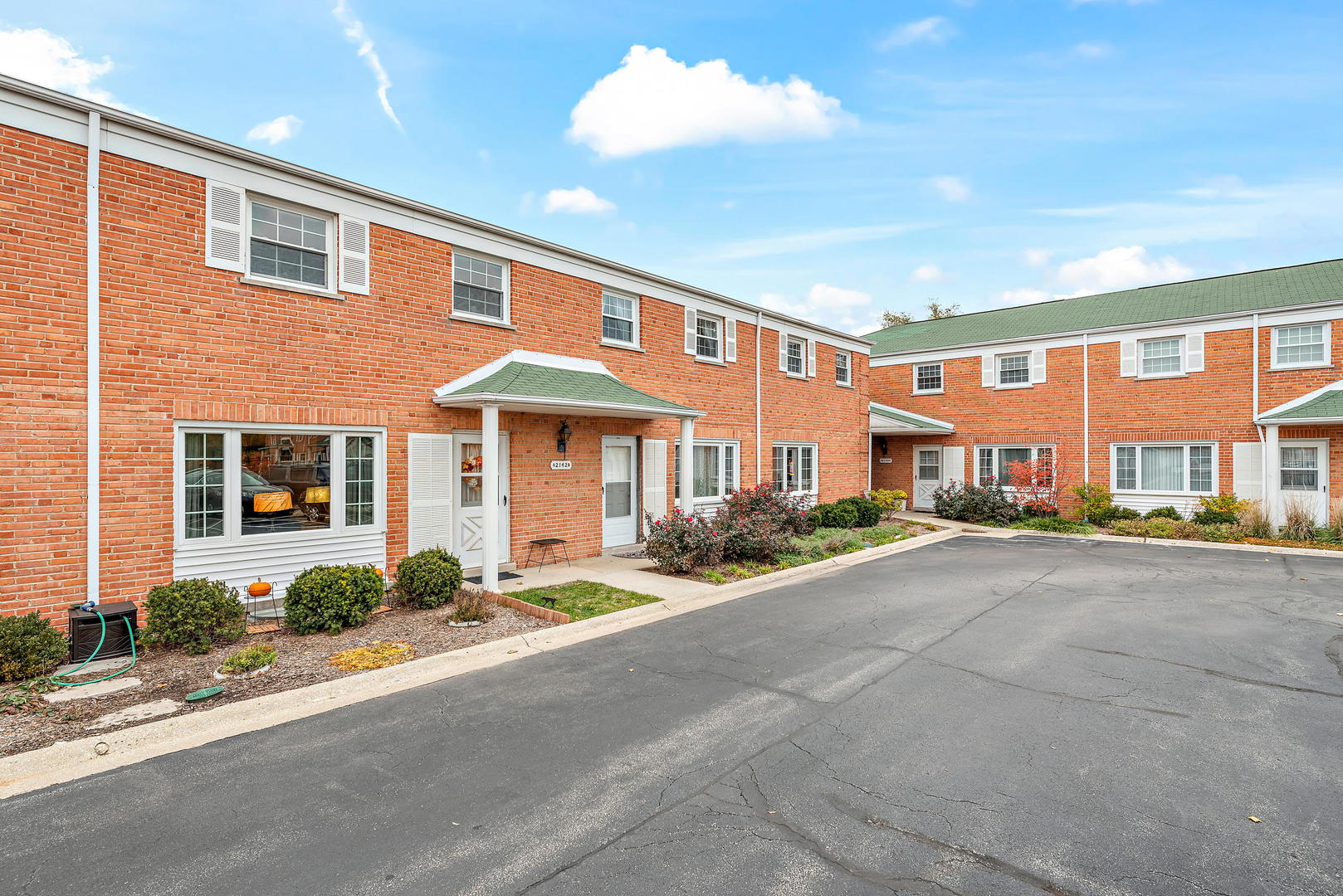 2142 Rugen Road, Unit C Glenview, IL 60026 - Photo 2 of 24 a front view of a brick building with many windows