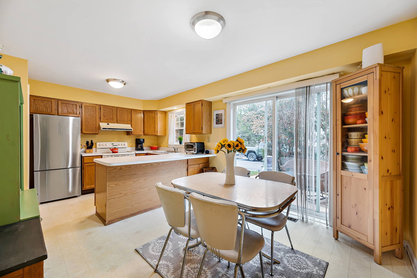 2142 Rugen Road, Unit C Glenview, IL 60026 - Photo 5 of 24 a kitchen with a dining table chairs and refrigerator