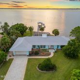 a aerial view of a house with garden space and outdoor seating