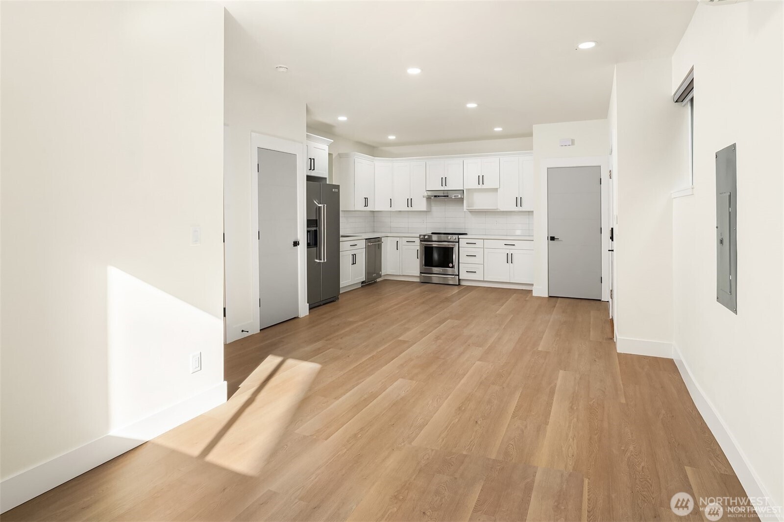 3817 Letitia Avenue South Seattle, WA 98118 - Photo 4 of 16 a open kitchen with white cabinets and stainless steel appliances
