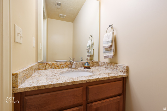 6761 950 East Midvale, UT 84047 - Photo 16 of 44 Vanity with a granite countertop, undermount sink, and chrome faucet
