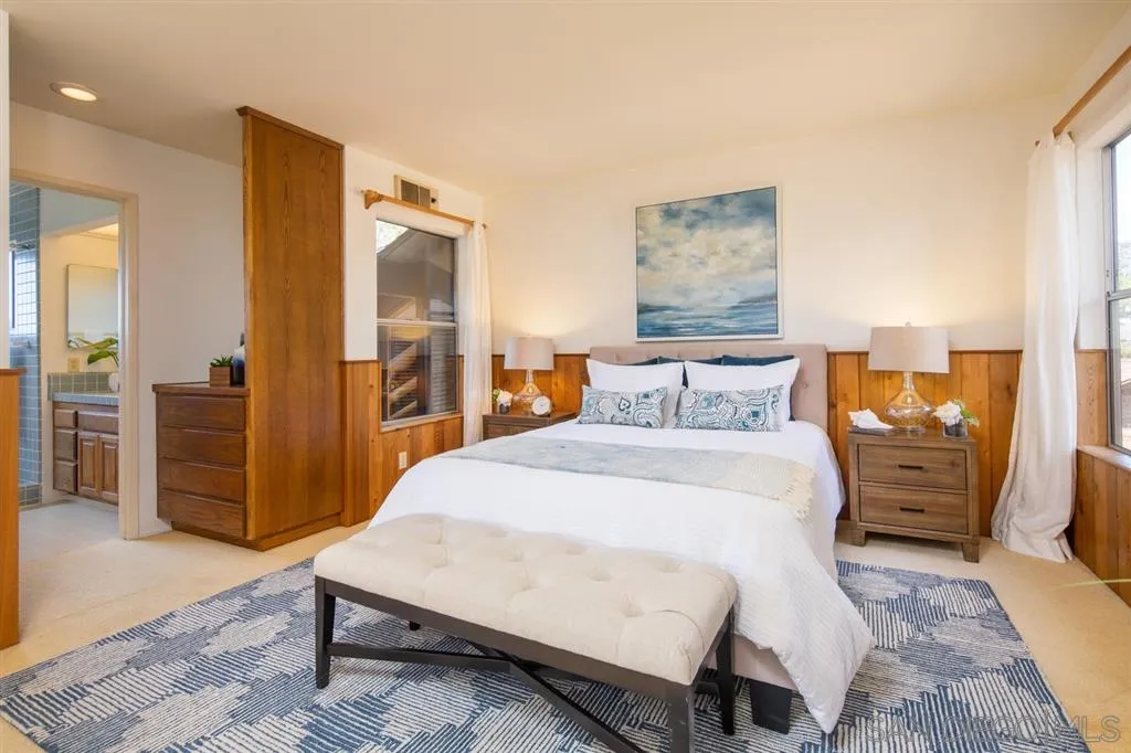 692 Rimini Road Del Mar, CA 92014 - Photo 11 of 25 a bed room with a bed and wooden floor
