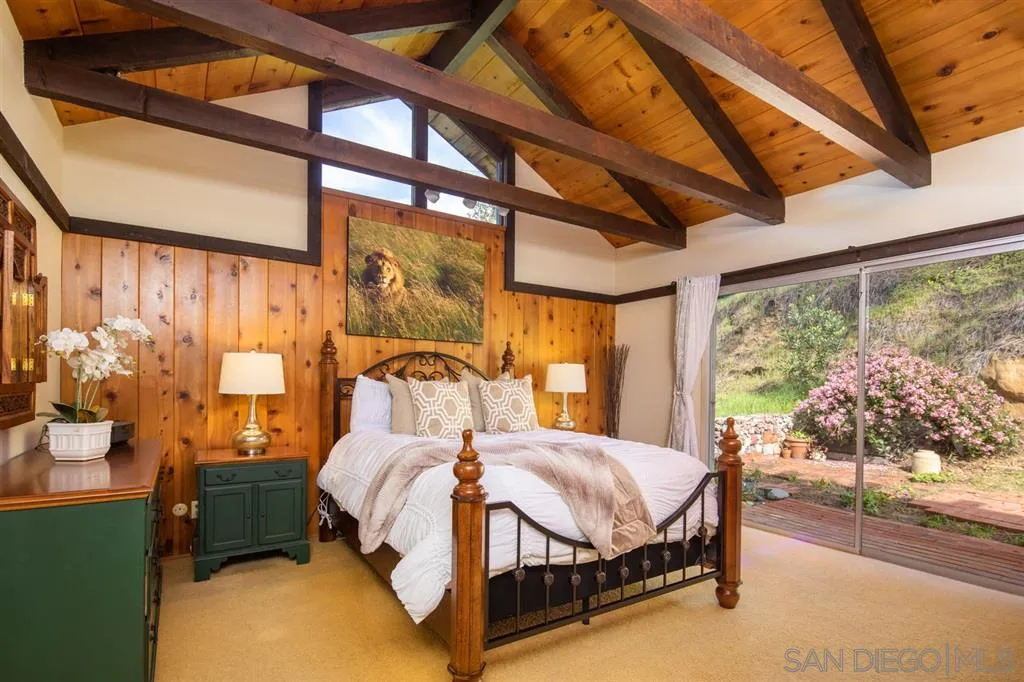 692 Rimini Road Del Mar, CA 92014 - Photo 14 of 25 a bedroom with a bed chair and a large window