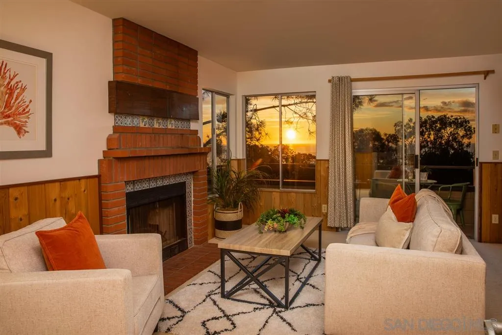 692 Rimini Road Del Mar, CA 92014 - Photo 20 of 25 a living room with furniture and a fireplace