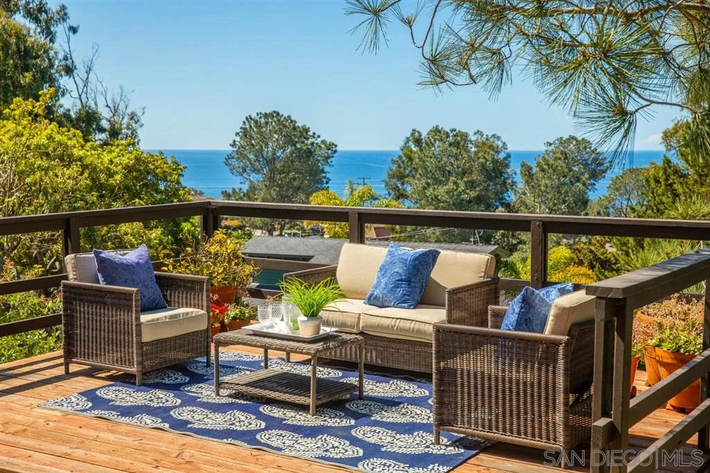 692 Rimini Road Del Mar, CA 92014 - Photo 3 of 25 a view of a balcony with couches and wooden floor