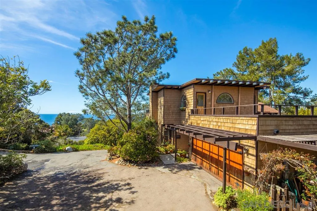 692 Rimini Road Del Mar, CA 92014 - Photo 5 of 25 a front view of a house with a garden