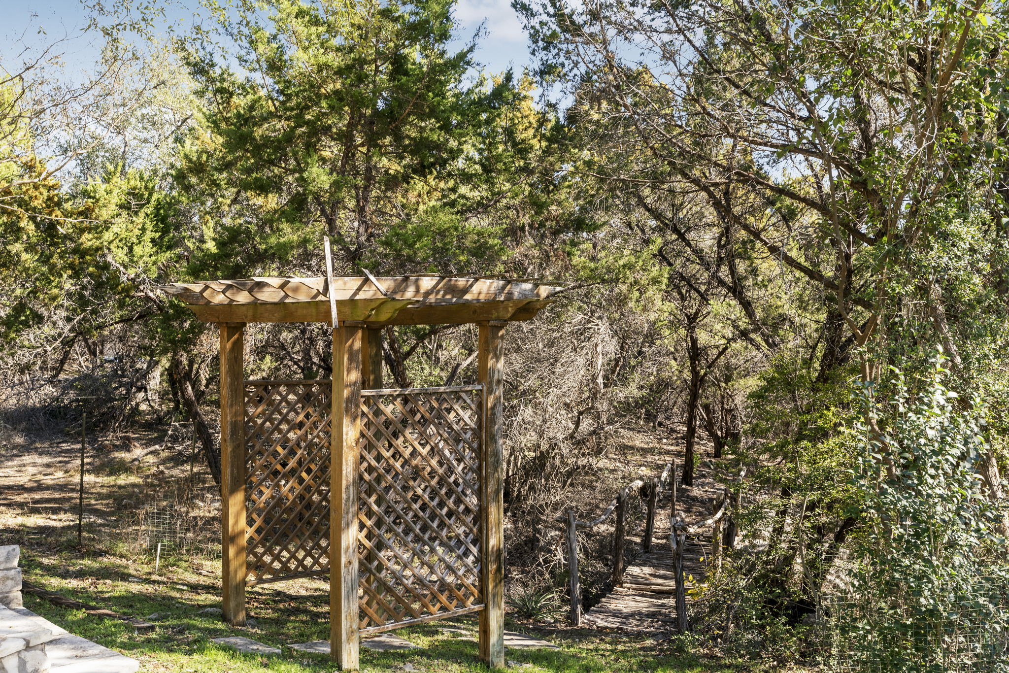701 Furlong Drive Austin, TX 78746 - Photo 35 of 38 Log bridge to Firepit area