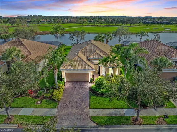 aerial view of a house with a garden and lake view