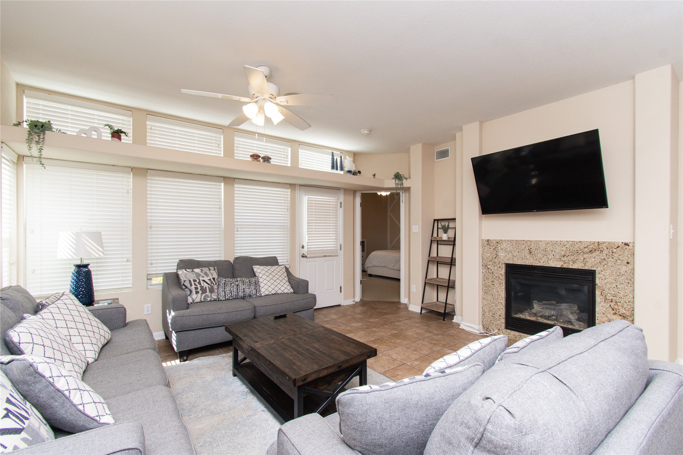421 Shadow Point San Marcos, TX 78666 - Photo 7 of 24 Living room featuring a ceiling fan and a high end fireplace