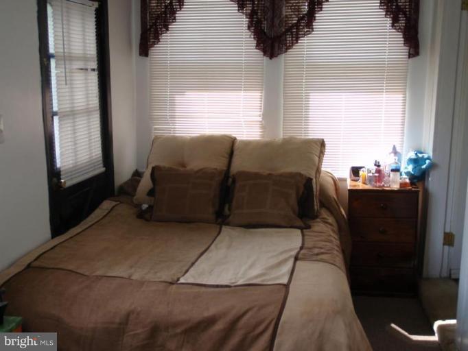 7917 Shore Road Sparrows Point, MD 21219 - Photo 11 of 16 a living room with furniture and a window