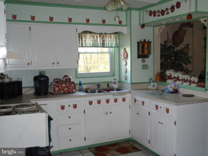 7917 Shore Road Sparrows Point, MD 21219 - Photo 3 of 16 a kitchen with cabinets and window