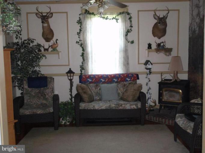 7917 Shore Road Sparrows Point, MD 21219 - Photo 5 of 16 a living room with furniture and a fireplace