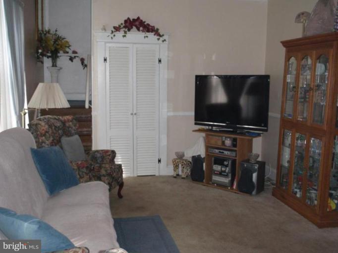 7917 Shore Road Sparrows Point, MD 21219 - Photo 6 of 16 a living room with furniture and a flat screen tv