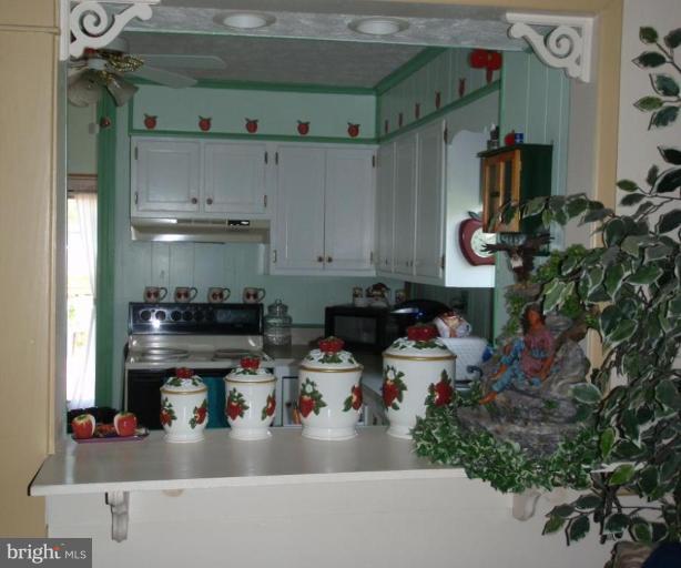 7917 Shore Road Sparrows Point, MD 21219 - Photo 10 of 16 a kitchen with sink refrigerator and stove