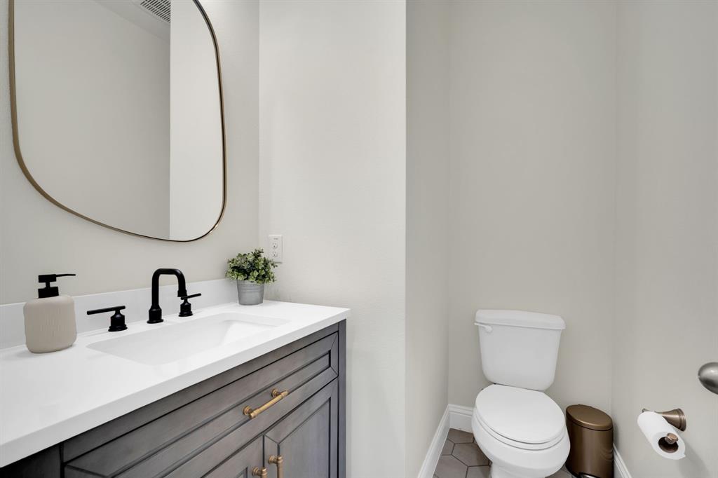 1601 Bear Path Way Gunter, TX 75058 - Photo 31 of 40 a bathroom with a toilet sink and mirror