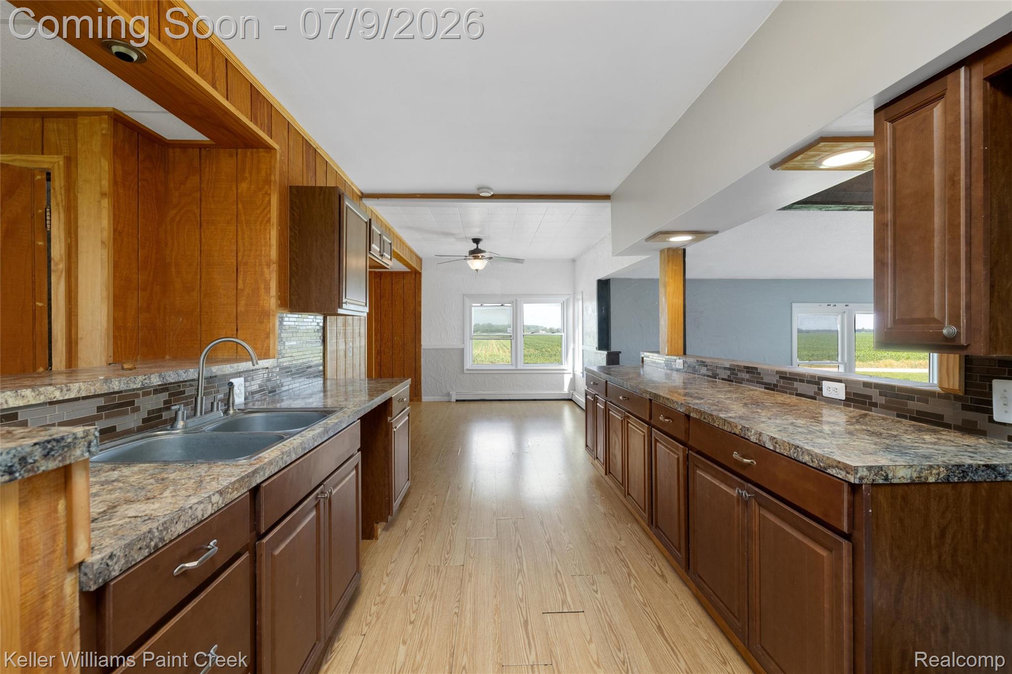 28780 School Section Road Richmond, MI 48062 - Photo 17 of 50 Spacious kitchen featuring extensive cabinetry, a double basin sink with an arched faucet, and wood-finish flooring