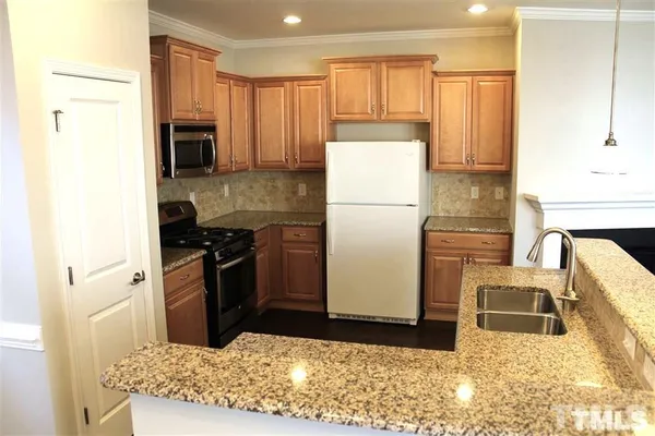 a kitchen with a refrigerator sink and stove