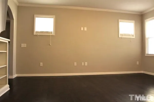 a view of a small space with wooden floor and a window