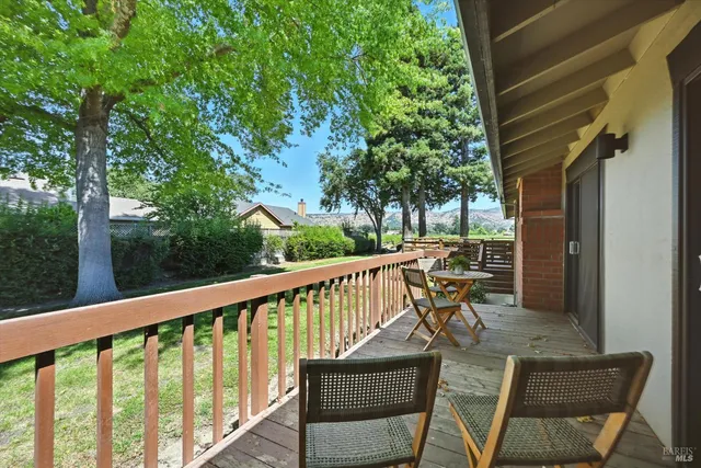 a view of a chairs and table in the balcony