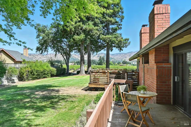 a view of a chairs and table in backyard of the house
