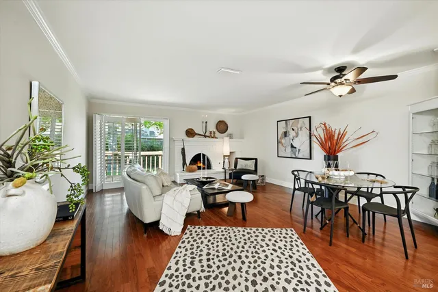 a living room with furniture a rug and a table