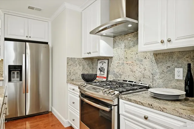 a kitchen with a stove and a refrigerator