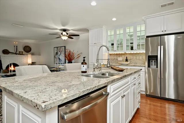 a kitchen with stainless steel appliances granite countertop a sink stove and refrigerator