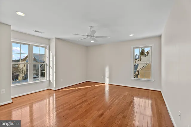 wooden floor in an empty room with a window