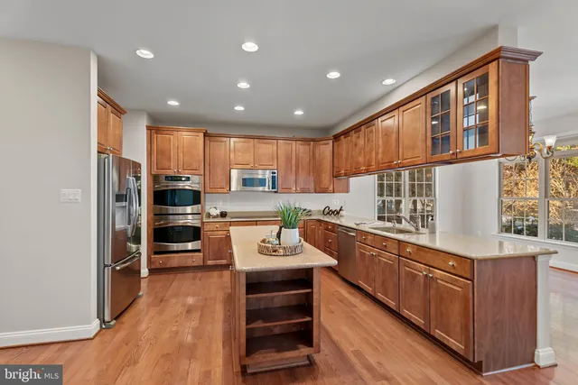 a kitchen with refrigerator cabinets and wooden floor