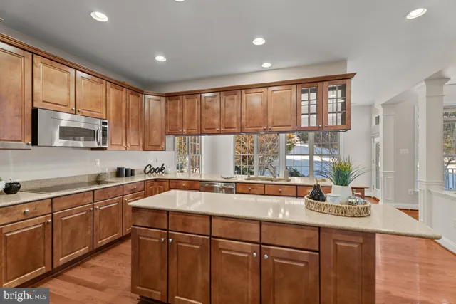 a kitchen with stainless steel appliances granite countertop a sink a stove and cabinets