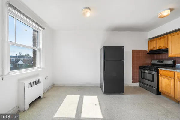 a kitchen with a refrigerator and a stove