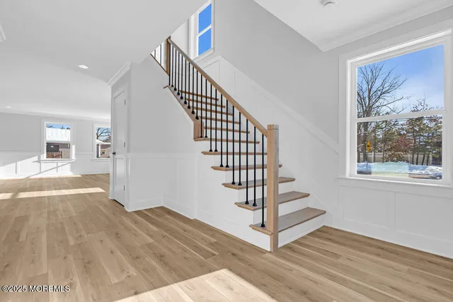 a view of entryway with wooden floor and front door