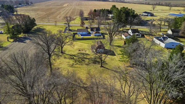 a view of a house with backyard and sitting area