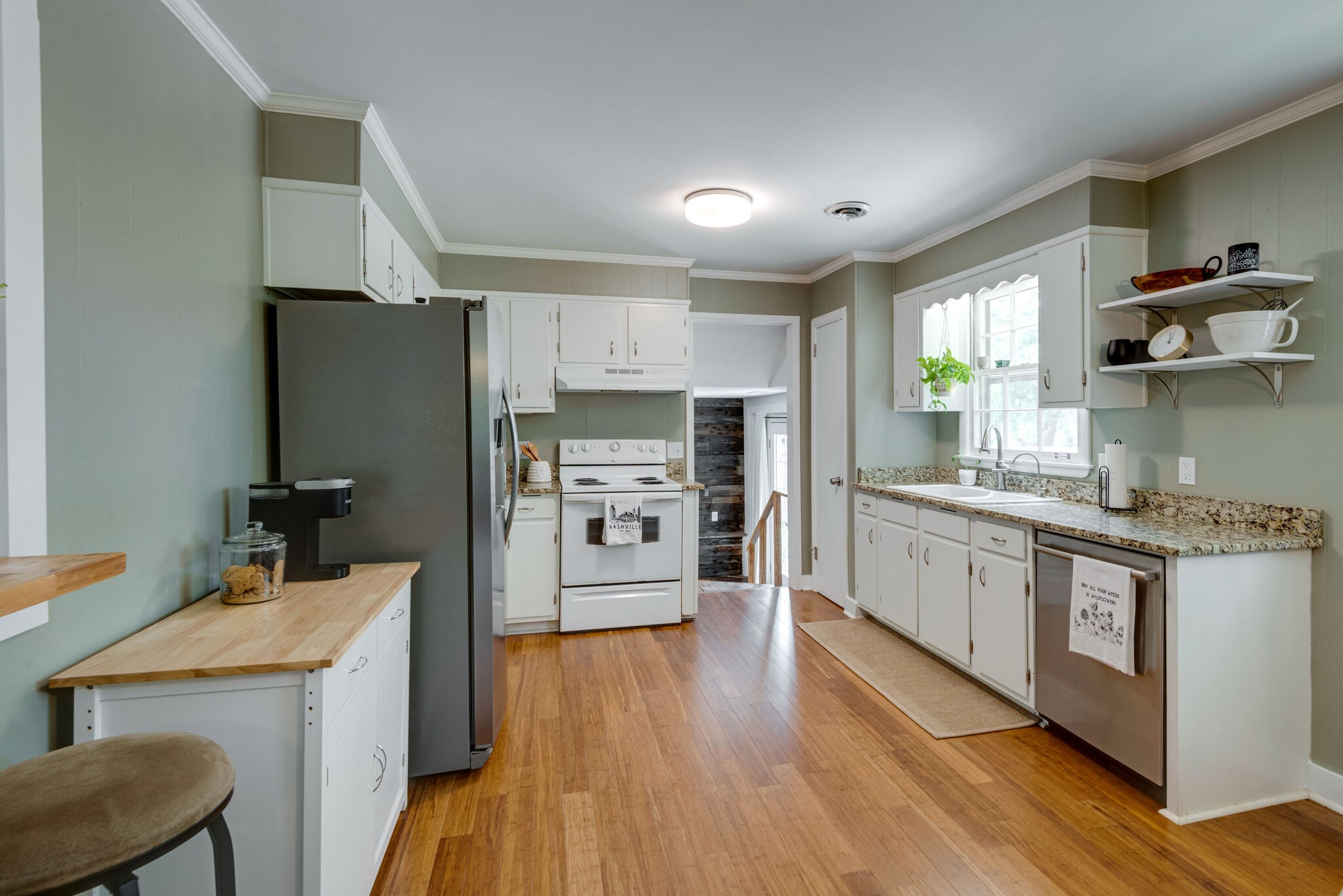 249 Bart Drive Antioch, TN 37013 - Photo 8 of 28 a kitchen with stainless steel appliances a sink a stove a refrigerator cabinets and wooden floor