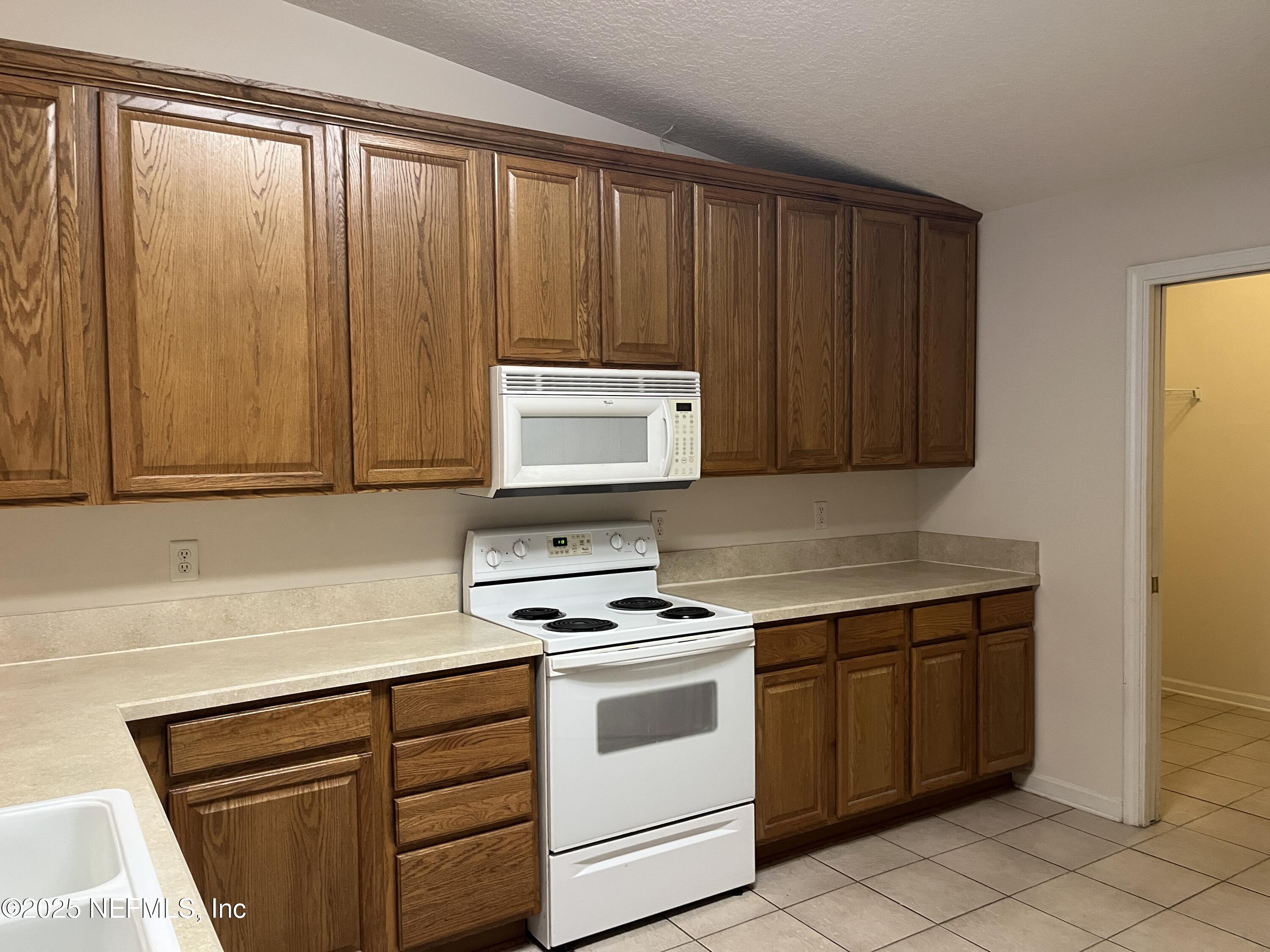 3898 Green View Terrace Middleburg, FL 32068 - Photo 10 of 43 a kitchen with granite countertop cabinets stainless steel appliances and sink
