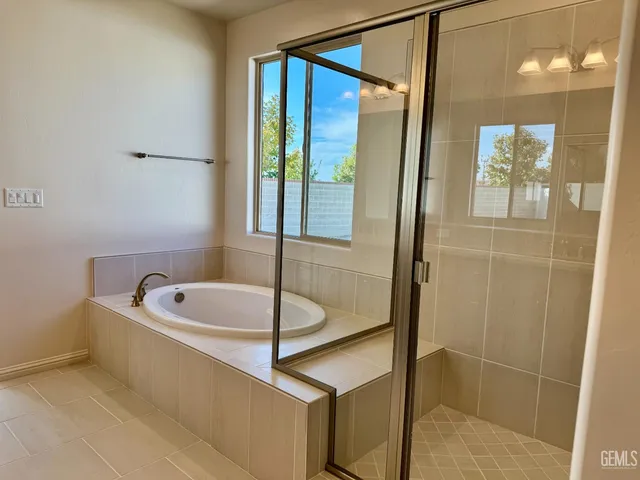 a bathroom with a tub and a shower