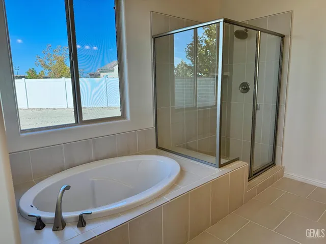 a bathroom with a tub and shower