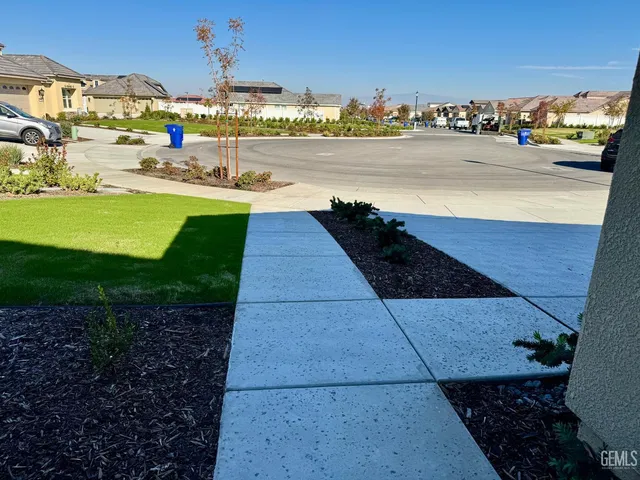 a front view of small house with garden