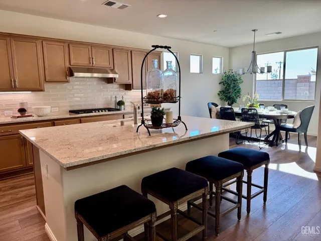 a kitchen with a table chairs stove and cabinets