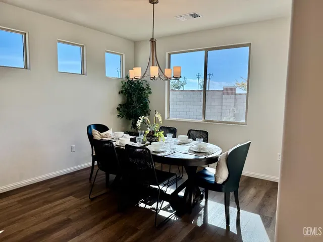a view of a dining room with furniture and window