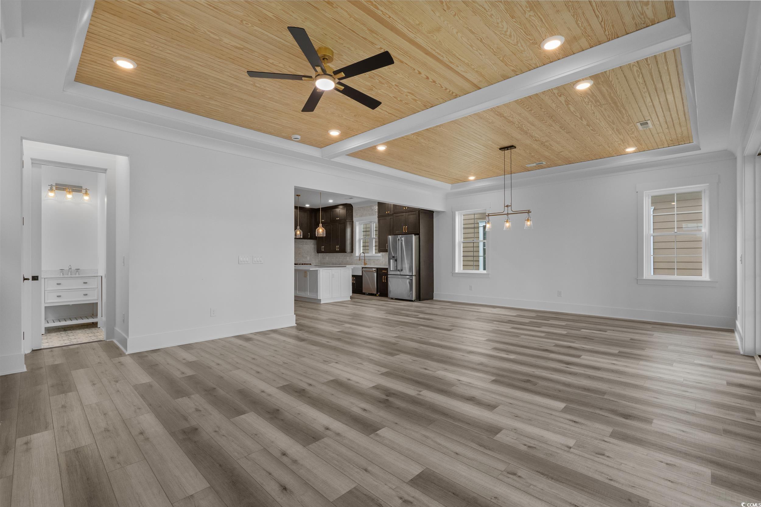 921 Crystal Water Way Myrtle Beach, SC 29579 - Photo 15 of 36 Unfurnished living room with wooden ceiling, recessed lighting, light wood-style floors, and ceiling fan