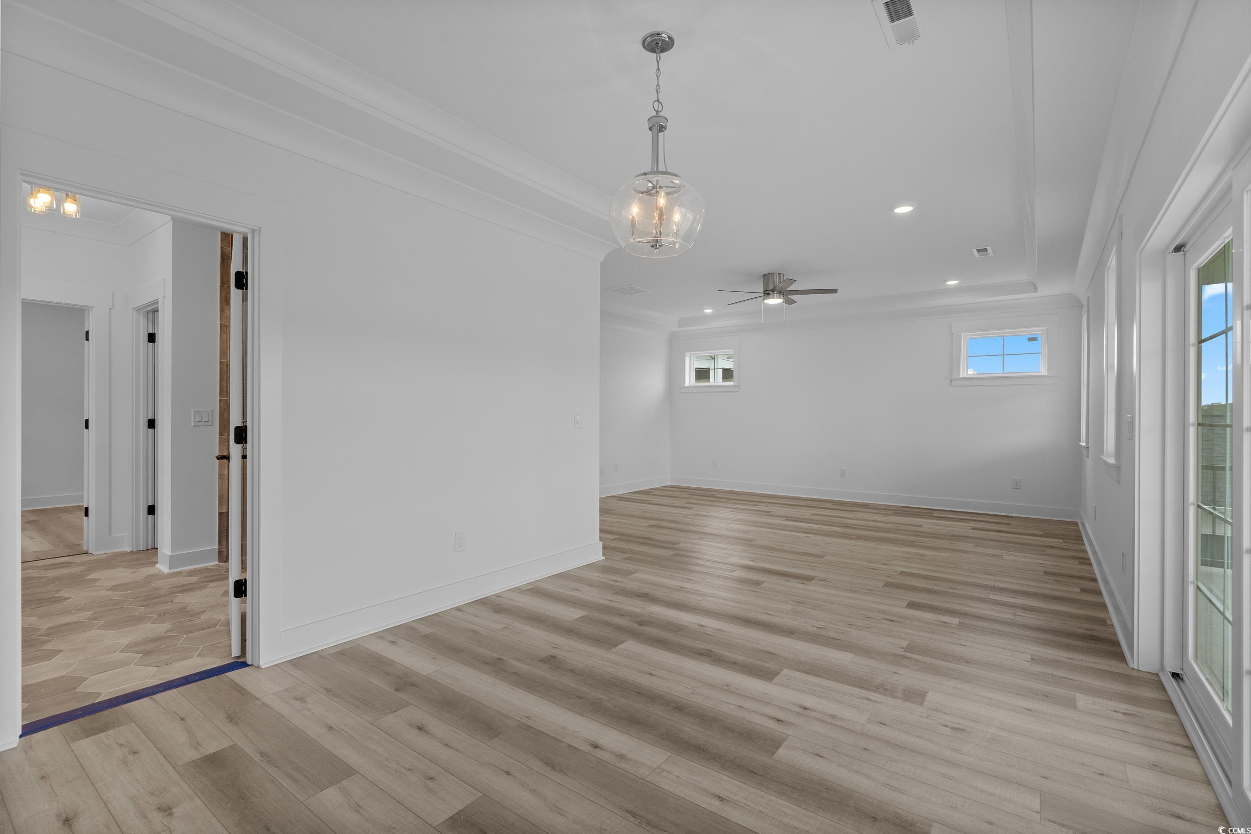 921 Crystal Water Way Myrtle Beach, SC 29579 - Photo 18 of 36 Unfurnished room with recessed lighting, light wood finished floors, ceiling fan, and crown molding