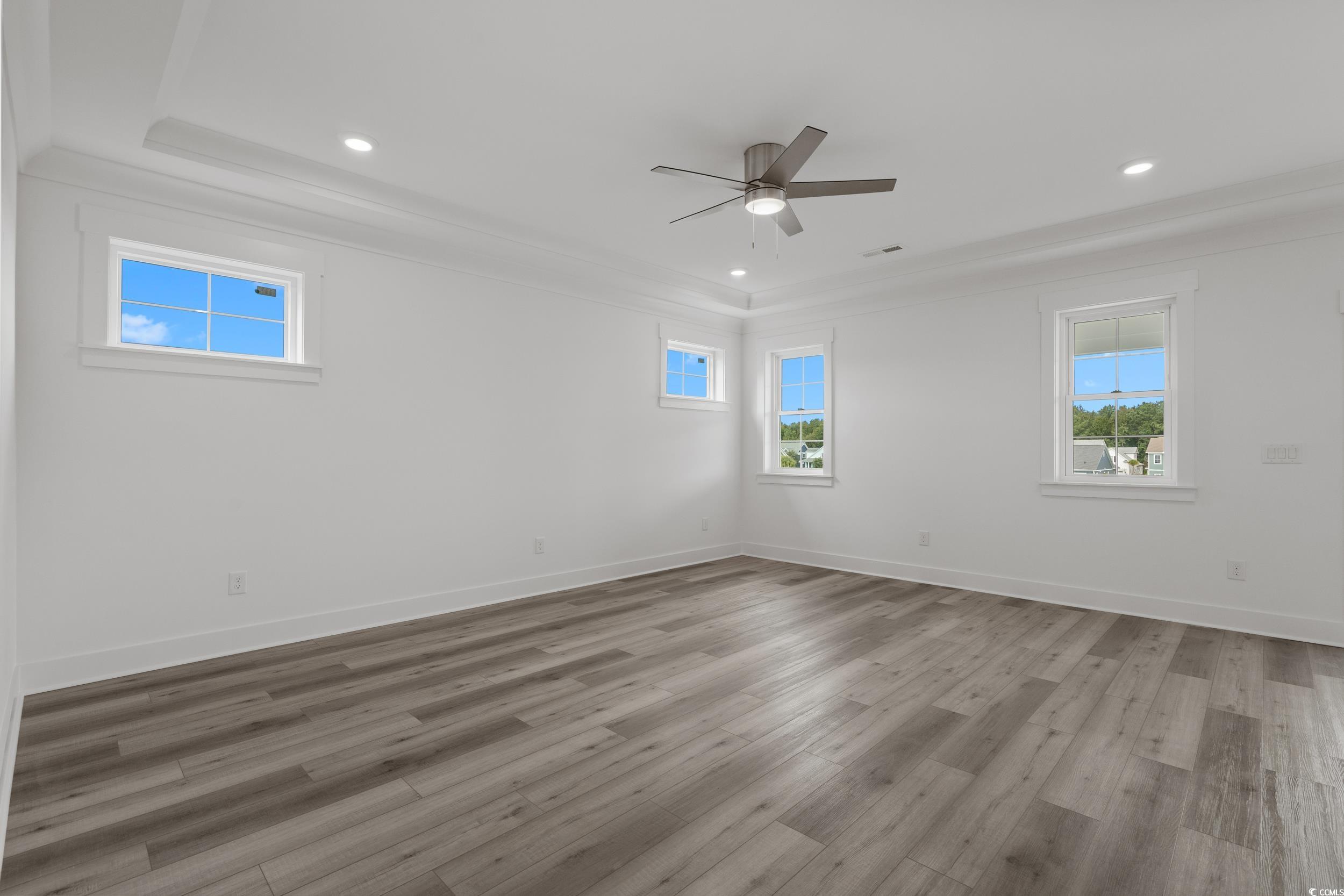 921 Crystal Water Way Myrtle Beach, SC 29579 - Photo 23 of 36 Spare room with crown molding, light wood finished floors, recessed lighting, and a ceiling fan
